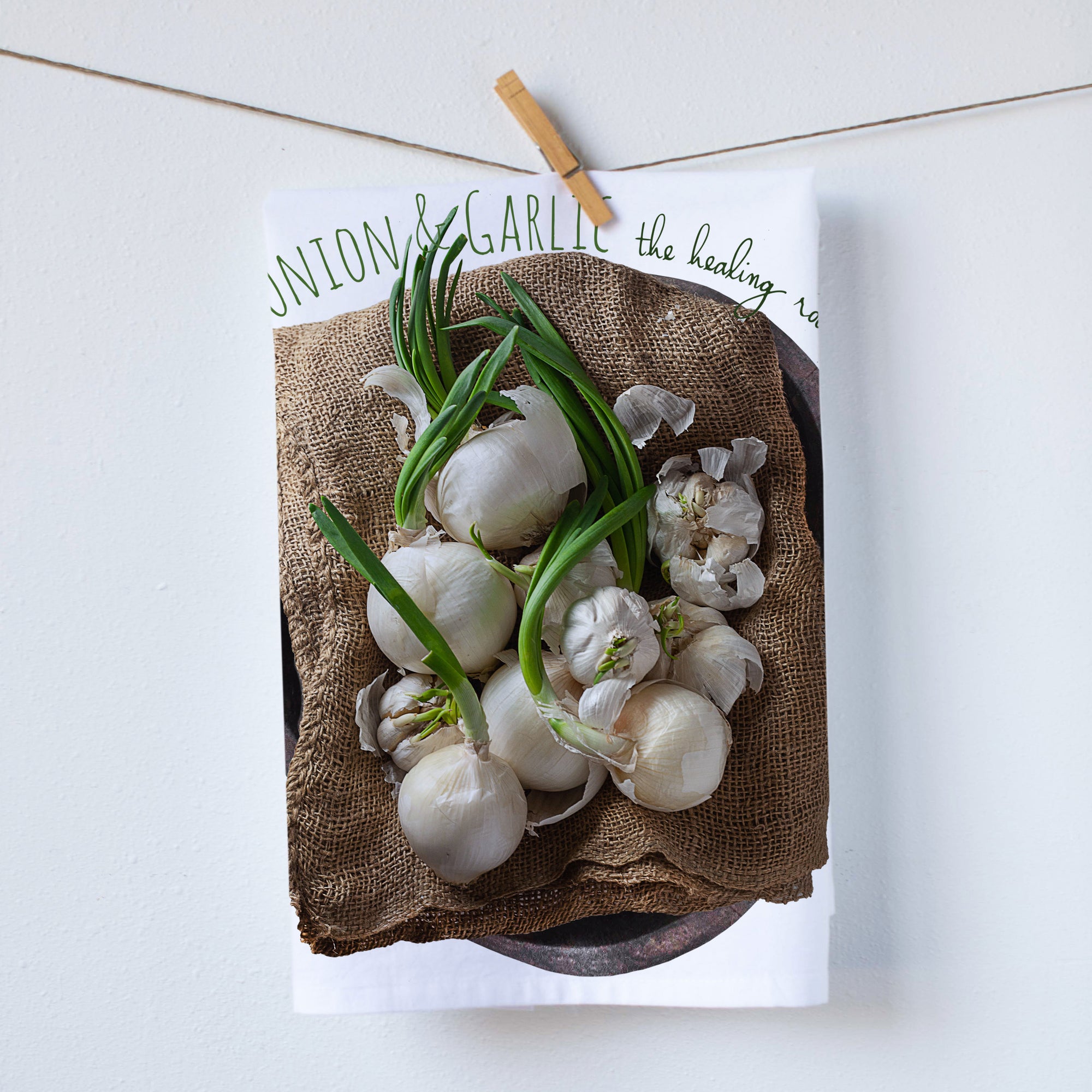 Garlic and onion kitchen towel. Garlic and onion placed on a flower sack. Full color photography. Photography by Pauline Stevens. Hostess Gift, 19" x 28"   (5331582746773)
