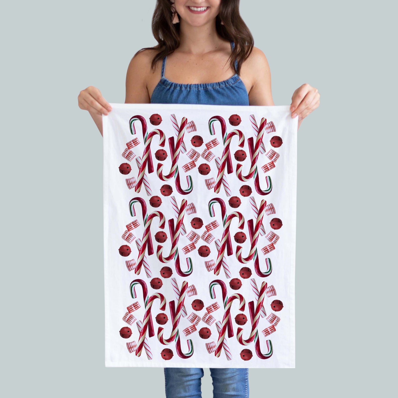 A festive 100% cotton kitchen towel Featuring a vibrant candy cane photo print
