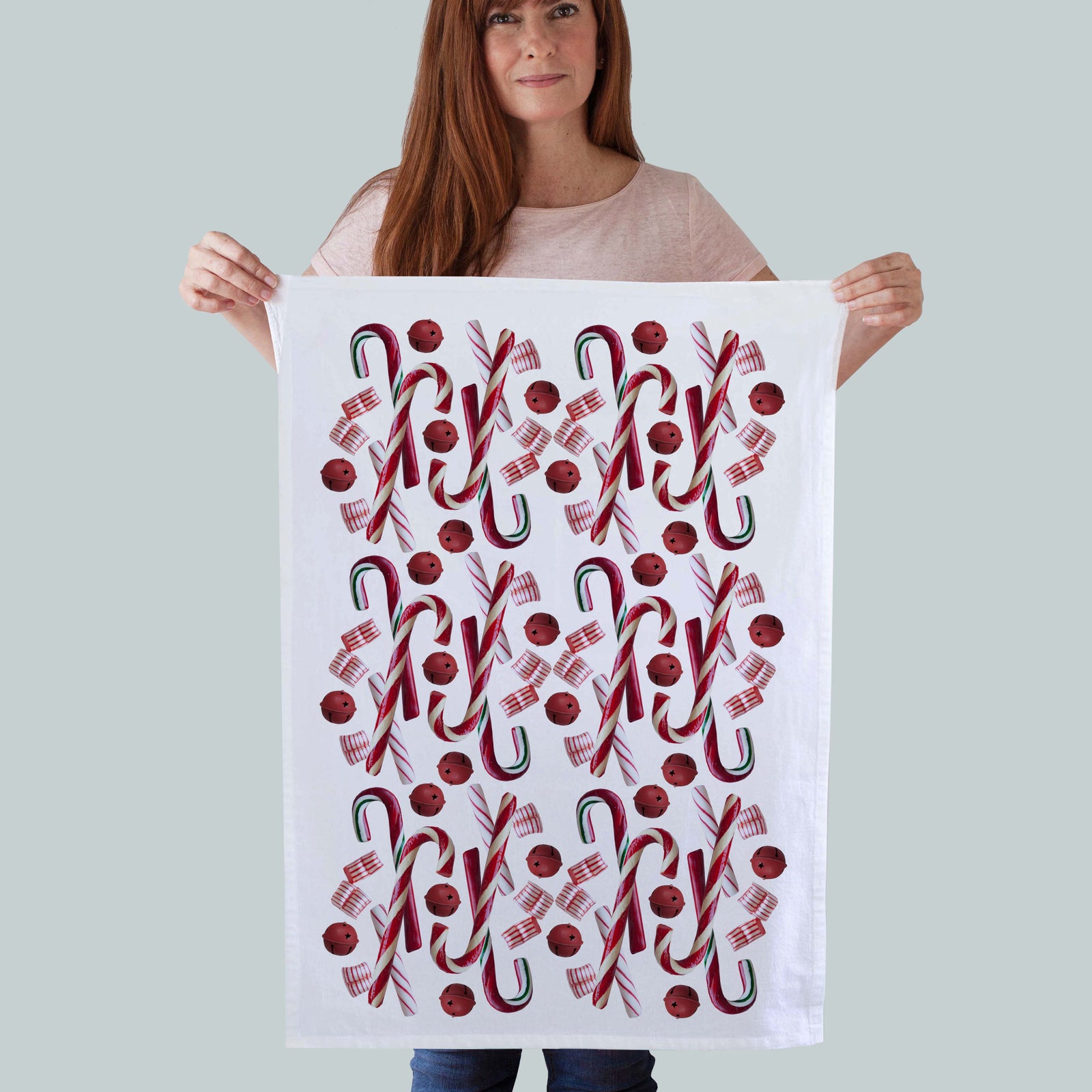 A festive 100% cotton kitchen towel Featuring a vibrant candy cane photo print