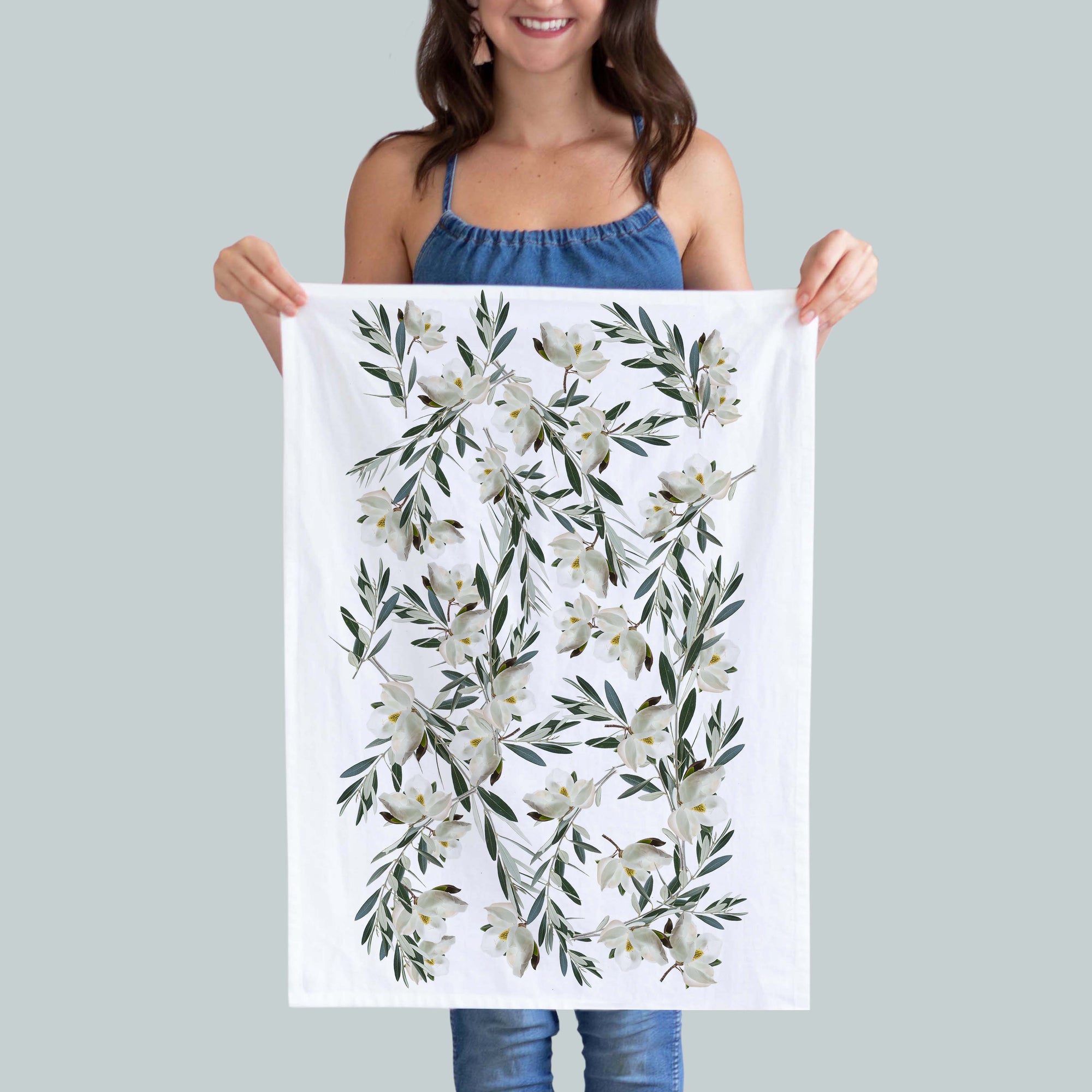 This elegant kitchen towel features arrangements of magnolias in shades of off white and green, adding a touch of sophistication to any kitchen.   Our dish towels are a perfect combination of style and practicality.  Size: 19"x 28" Print size 16"x18" 100%  Cotton Gift Ready Packed Machine wash  Exclusively at Red BIrd's House Copyright owned by Pauline Stevens.