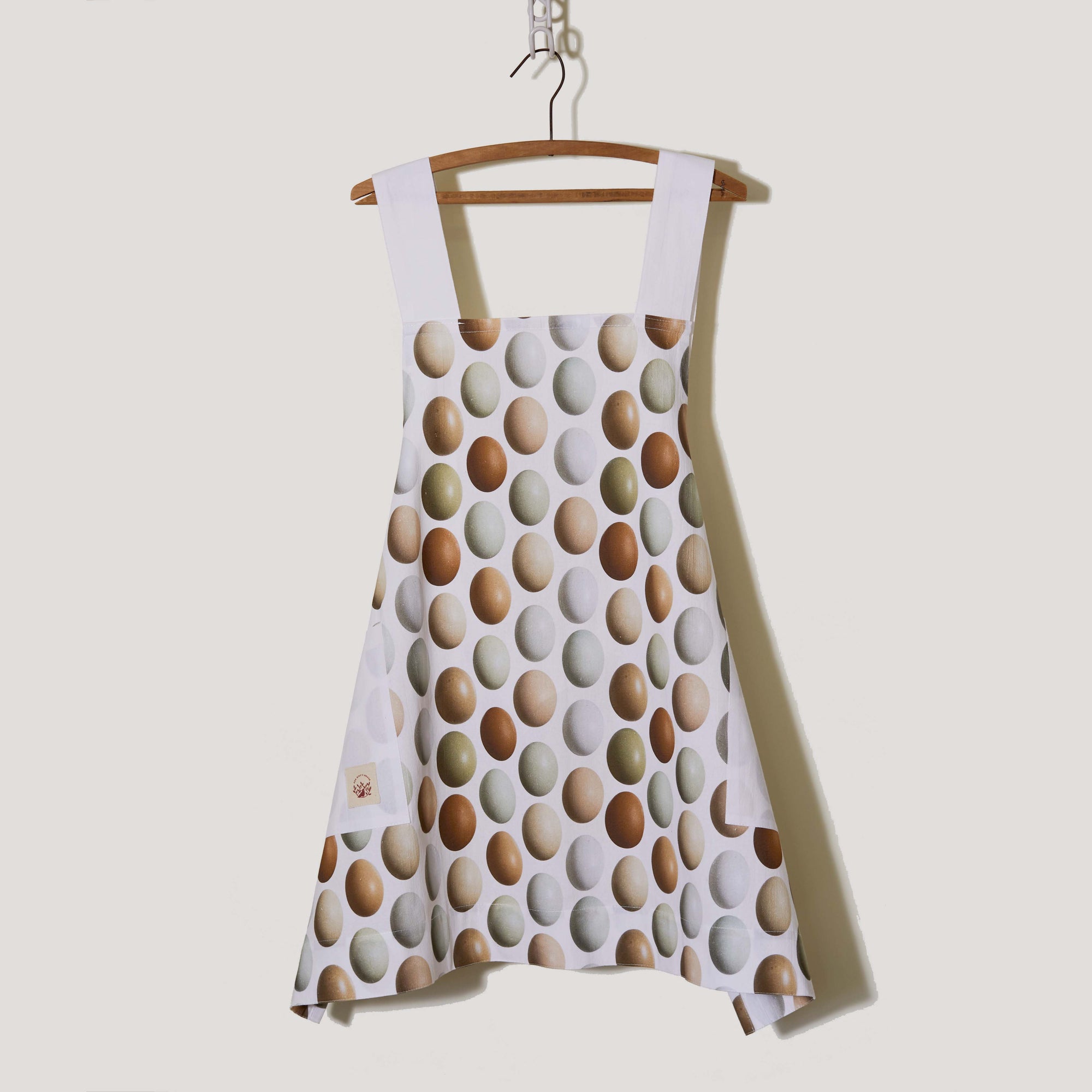  With its eye-catching criss-crossed design in the back and practicality, our cotton apron is a true kitchen essential. Whether you're a passionate baker, an aspiring chef, or a home lover seeking the perfect blend of style and functionality, this apron is sure to impress. Elevate your cooking experience today!  Features  Size: 35"x 27"  Straps-30"  Pockets: 8"  One size fits most Original photography by Pauline Stevens Photography Maxchine wash/Tumble dry No bleach